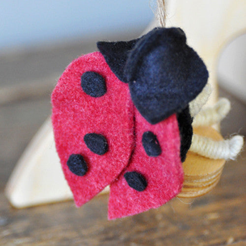 This Lady Bug fairy (faerie) is dressed in plant dyed wool felt and has a bendable body, giving it the movement to fly.